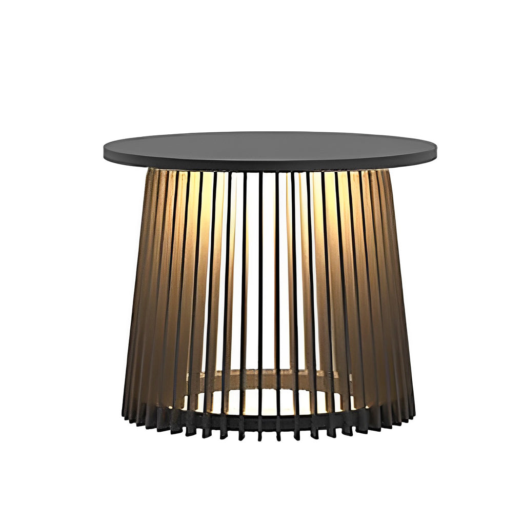 Solar coffee table with a black finish, providing ambient light in a garden.