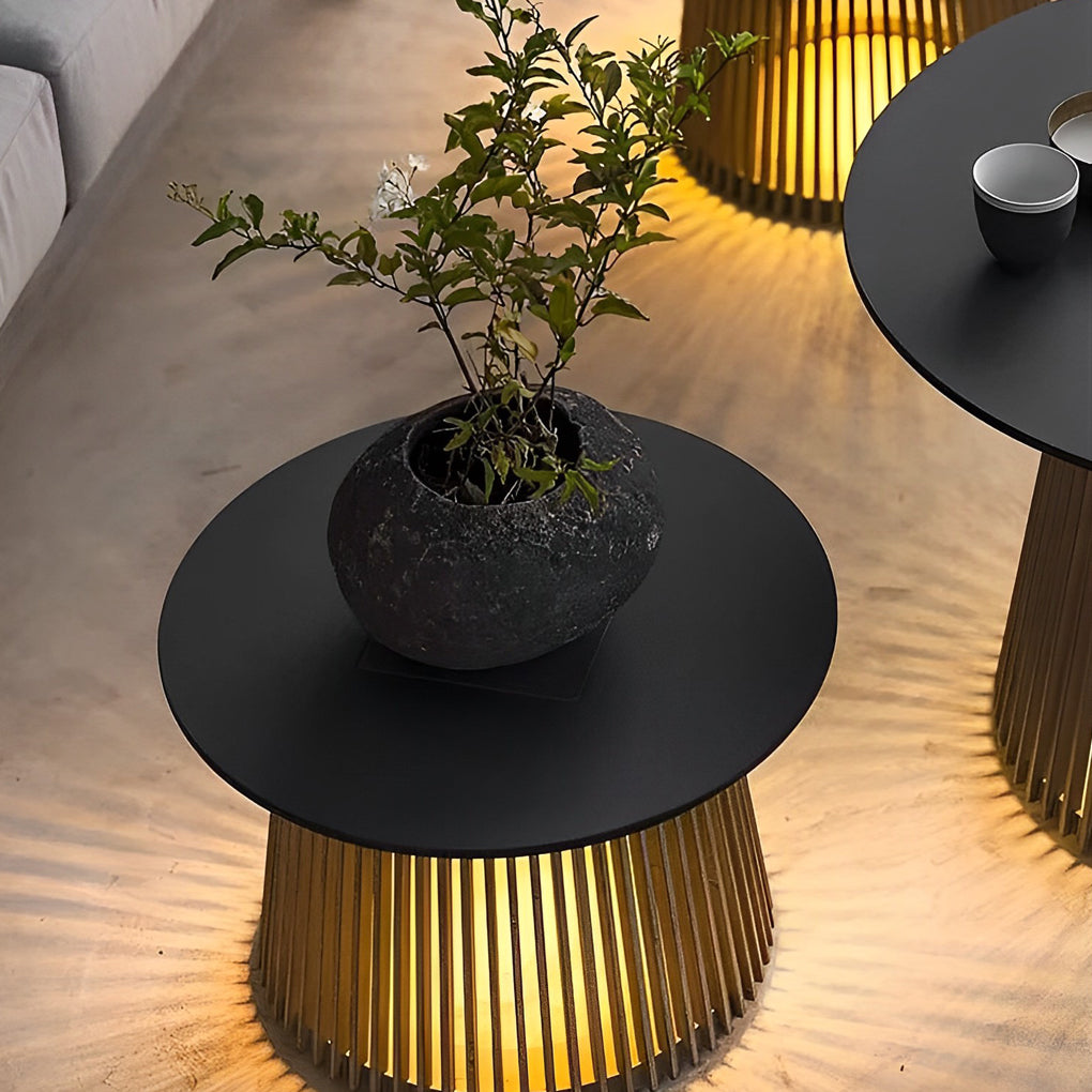 Solar coffee table with a black tabletop, providing soft illumination near a chair.