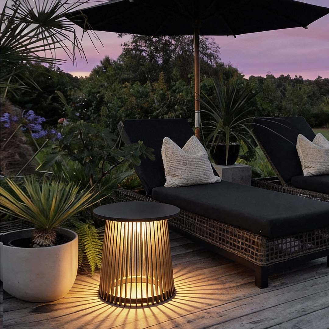 Solar coffee table with a woven design, providing warm illumination on a patio.