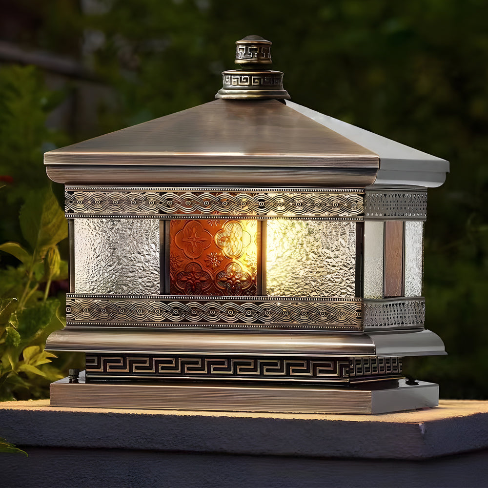 Solar column pillar lights resting on stone columns in a garden setting, blending classic design with modern solar technology.
