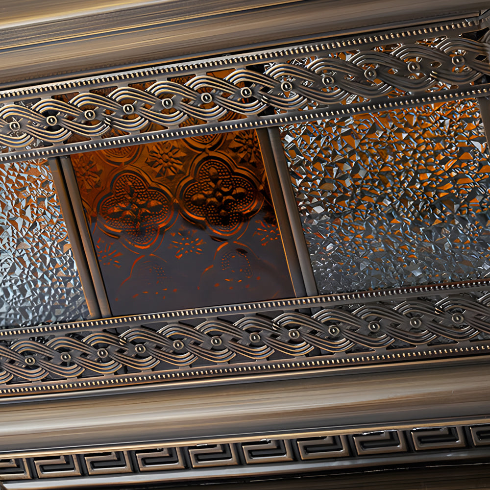 Macro detail of solar column pillar lights highlighting the embossed glass texture and decorative metal trim.