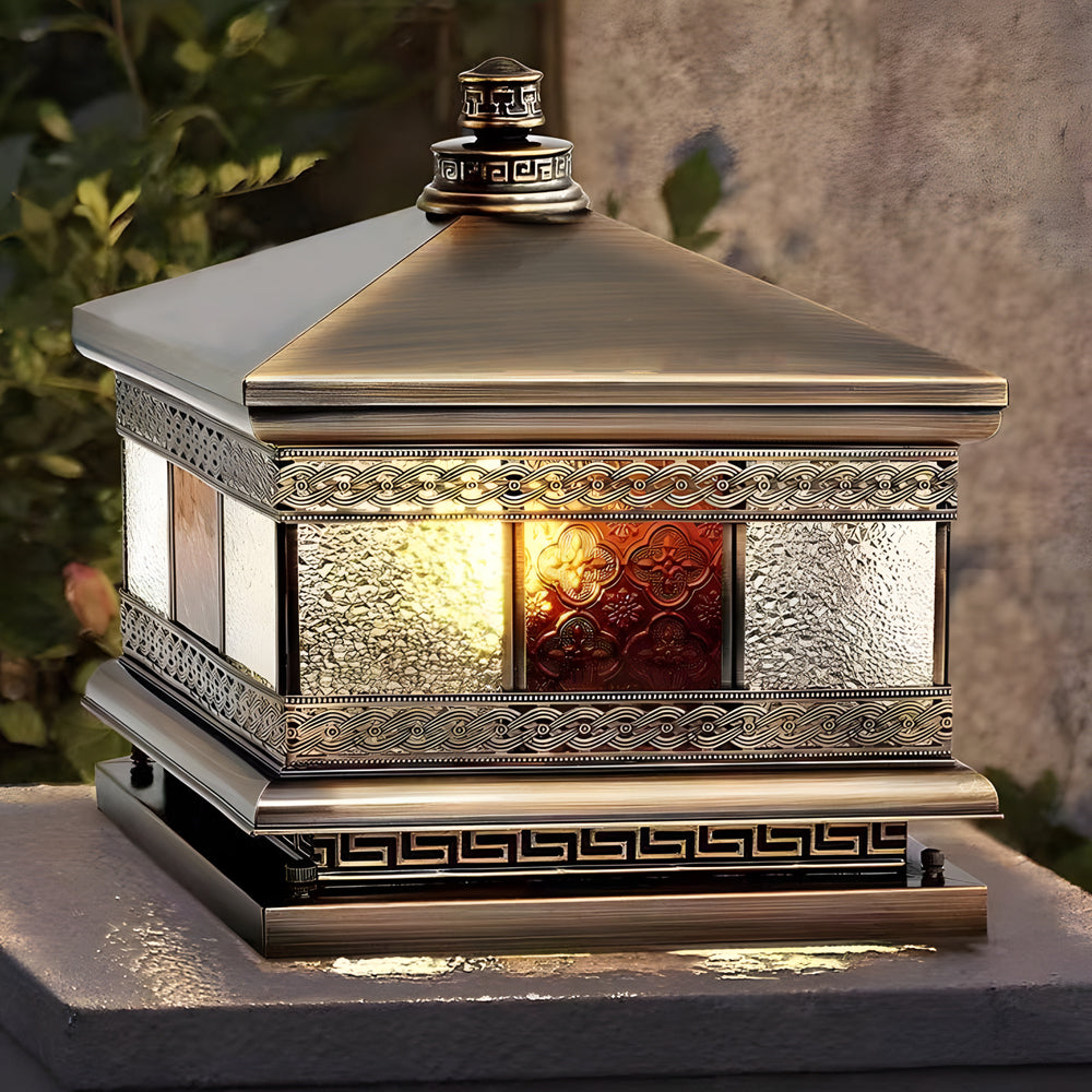 Close-up of solar column pillar lights showcasing ornate metal patterns and warm LED light behind patterned glass.