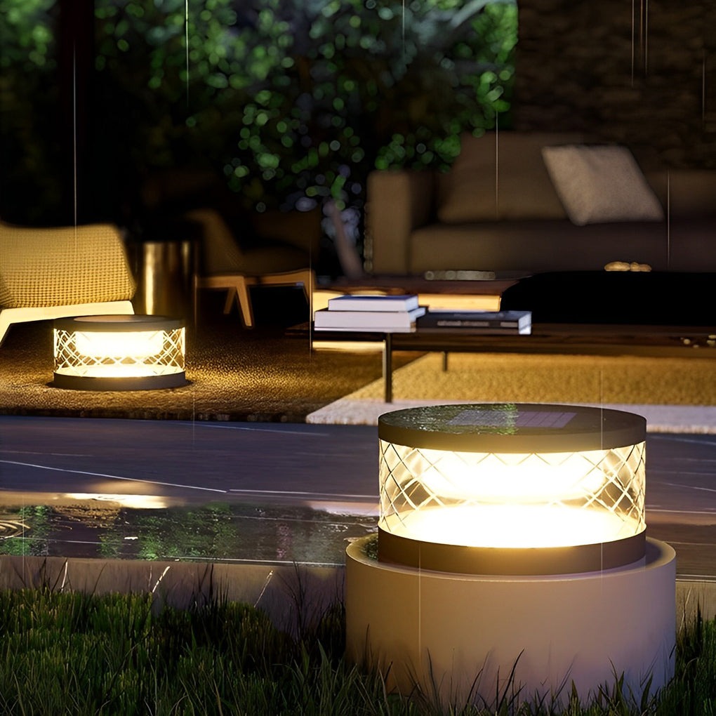 Solar cylinder pillar light with a modern design, enhancing an outdoor seating area.