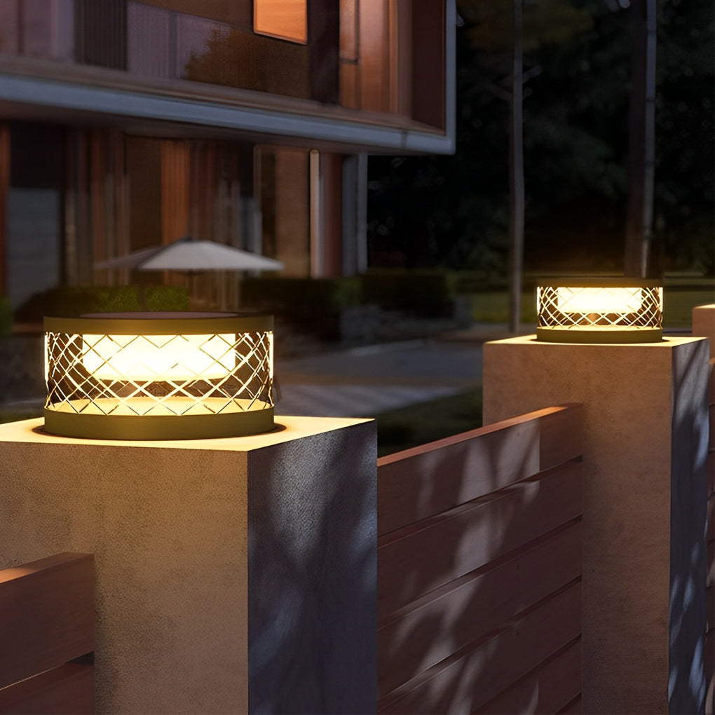Solar cylinder pillar light with a solar panel, installed on a stone pillar.