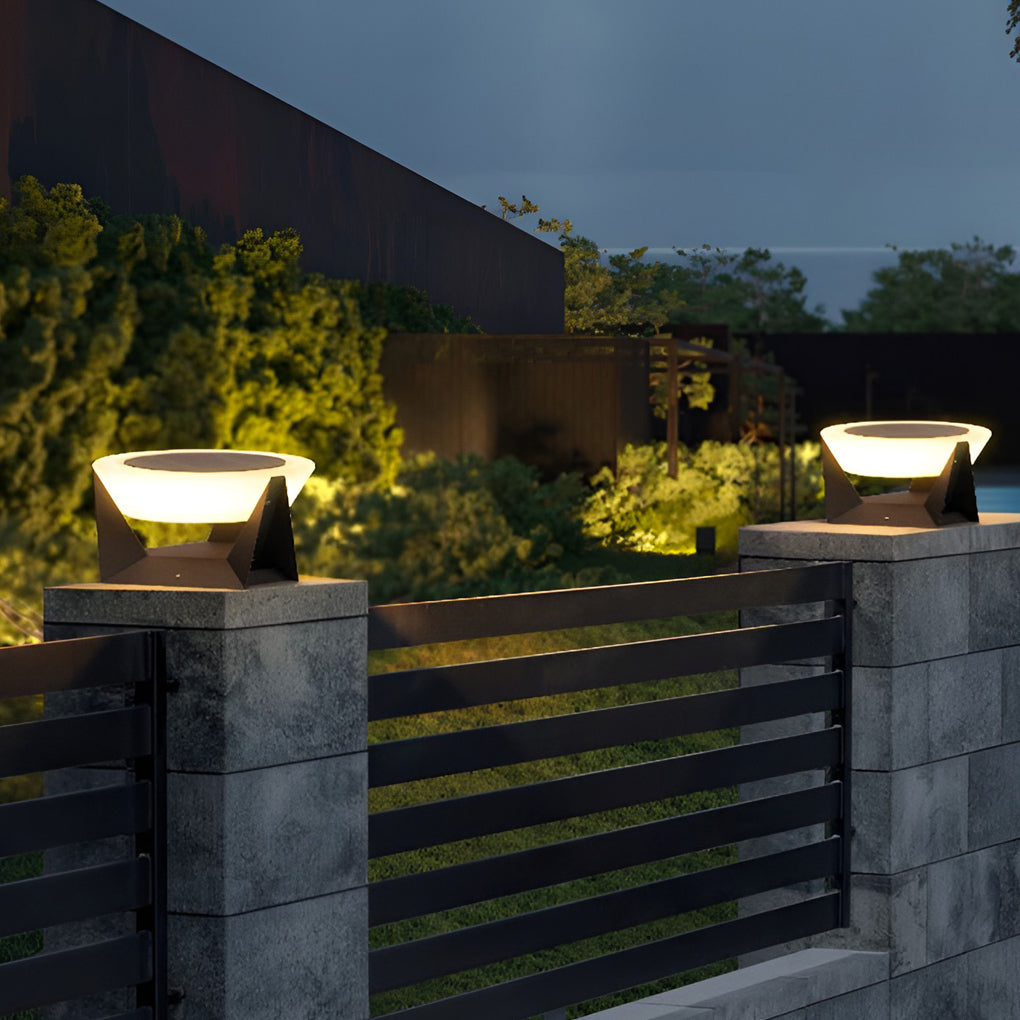 Solar fence pillar light mounted on an outdoor gate pillar, illuminating the entrance pathway after sunset.
