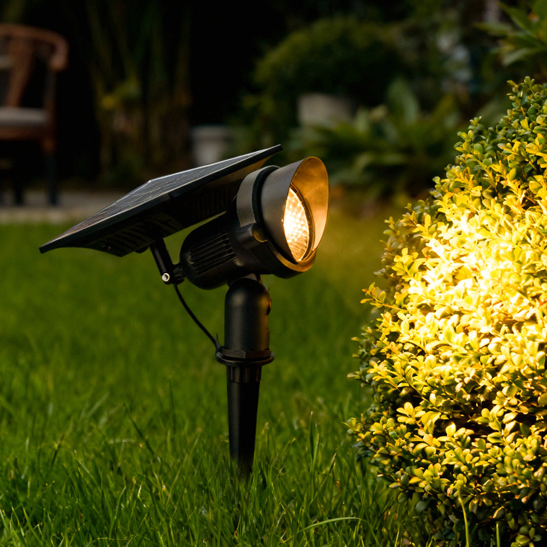 Lawn spot lights with solar panel, providing focused illumination on grass and plants for stylish garden lighting