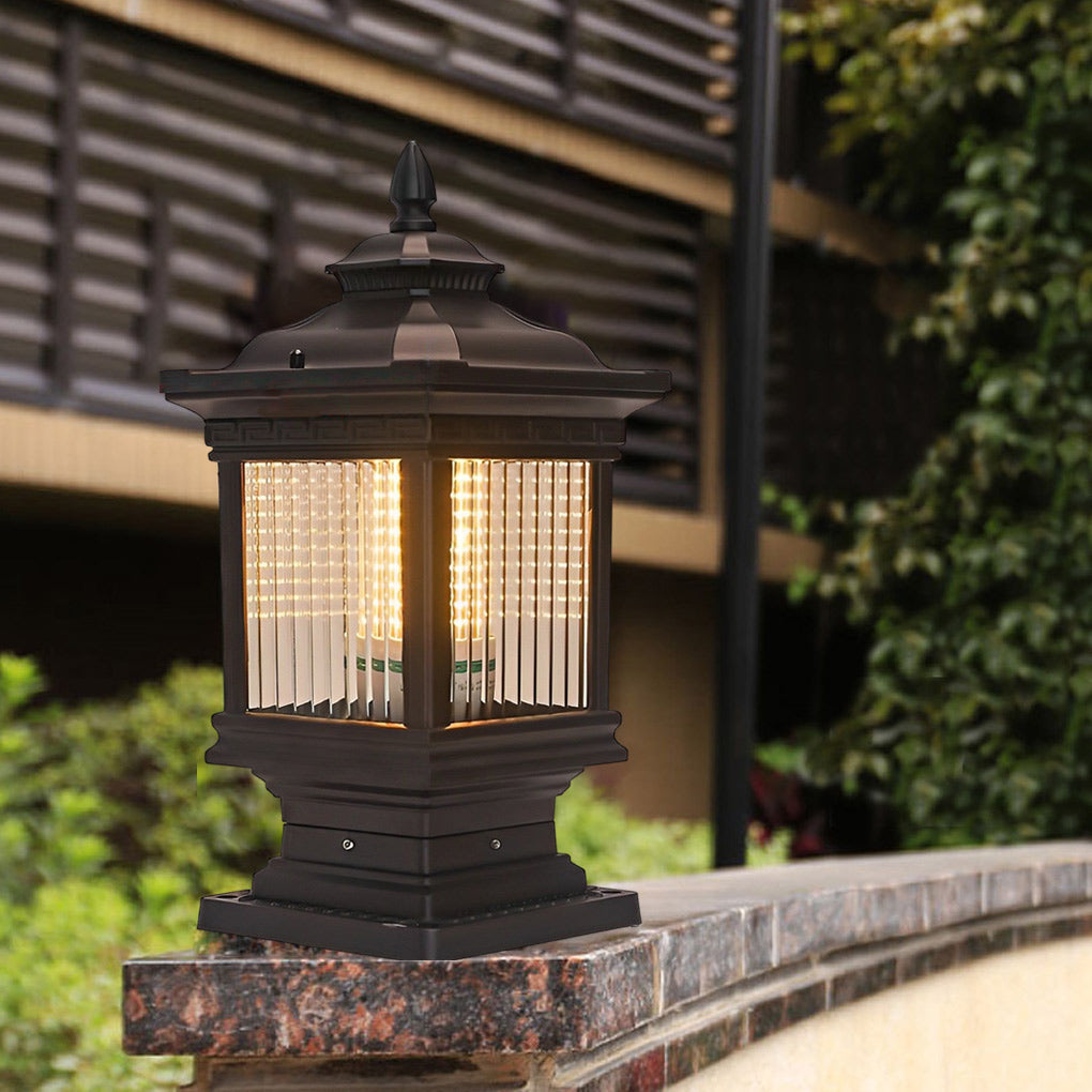 Solar garden post lights glowing warmly on a stone ledge, creating a welcoming atmosphere in the garden.