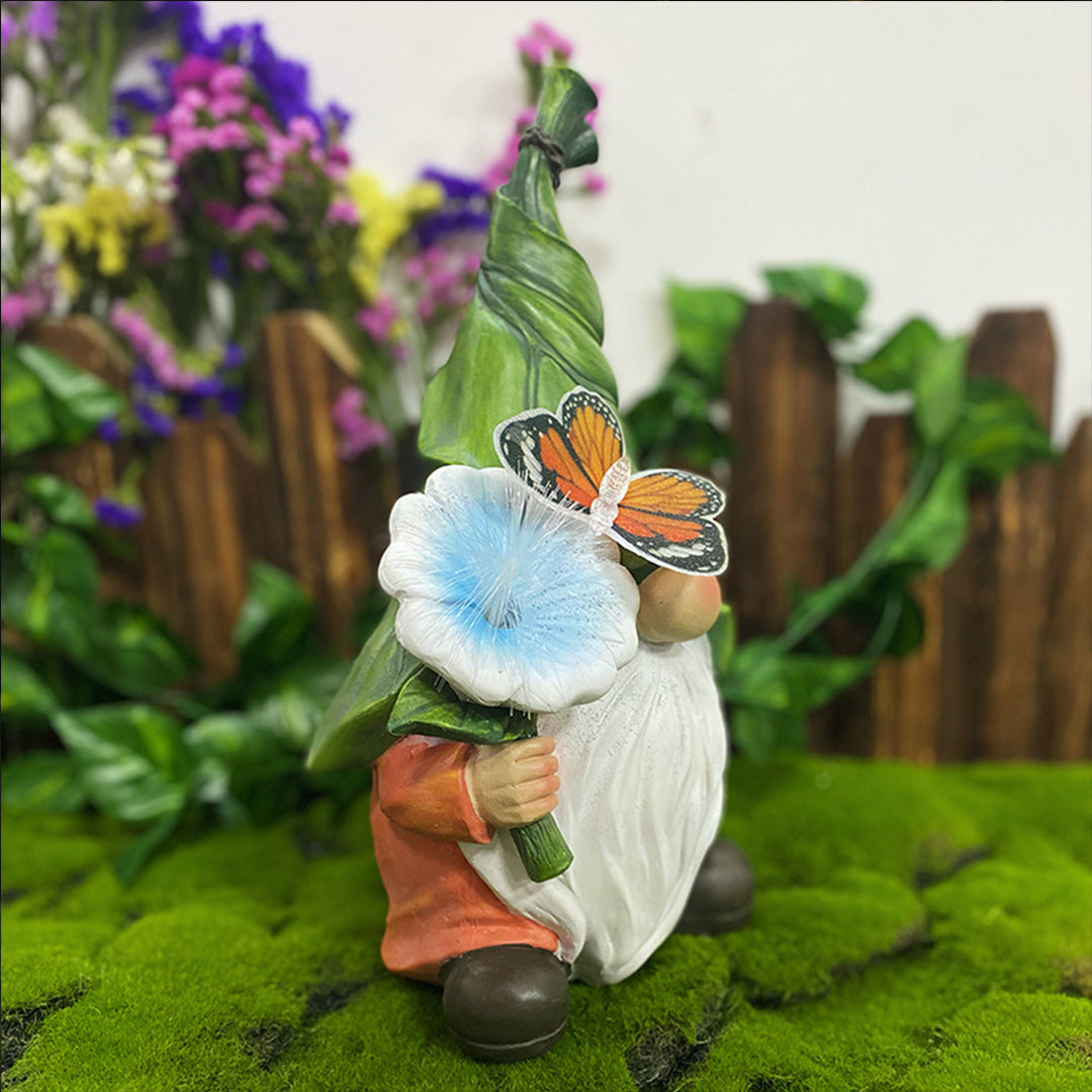 Solar gnomes garden lights providing soft light beside a gnome with a blue flower.