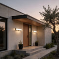 Solar light outdoor wall mount with a modern design, mounted above a wooden door.
