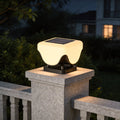 Solar lights for pillar tops installed on stone fence post with warm modern outdoor illumination.