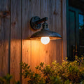Rustic outdoor solar lights wall fixture installed on wooden exterior with warm illumination.