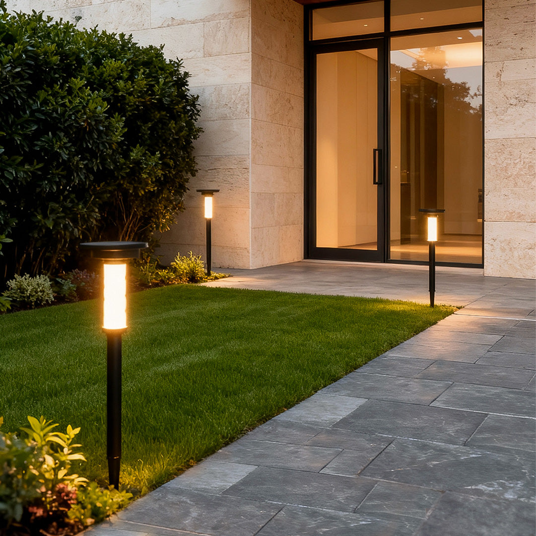 Solar outdoor path lighting placed along home entrance walkway creating a warm, welcoming nighttime glow.