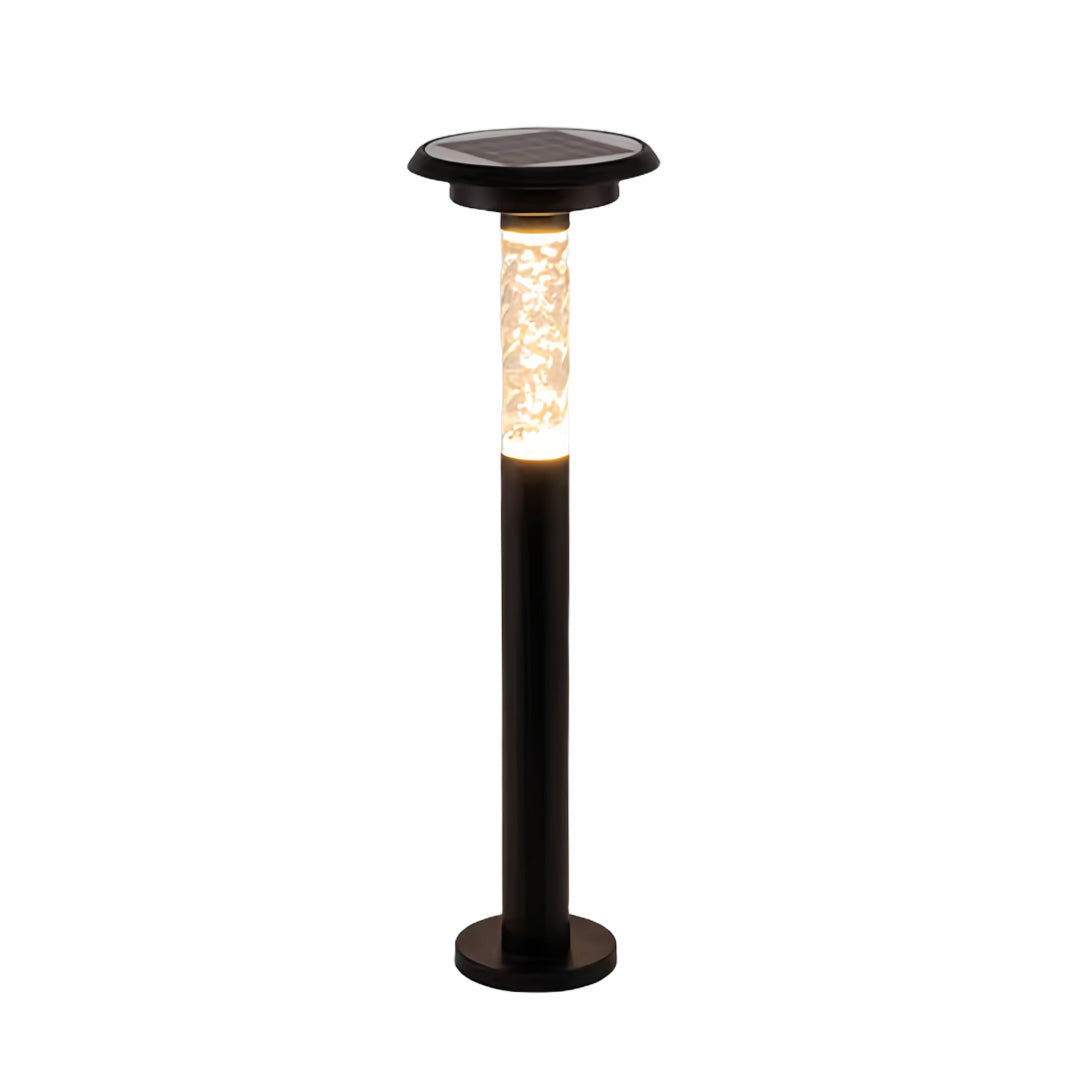 Tall solar outdoor path lighting fixture with ribbed diffuser providing warm garden illumination on white background.