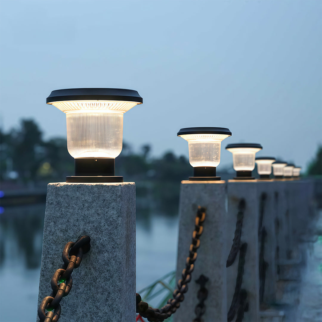 Bright solar pillar light shining on a residential porch wall, offering stylish outdoor lighting.