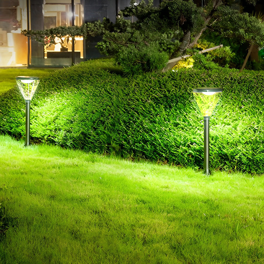 Solar powered lawn light with a sleek black finish, glowing softly in a garden setting.