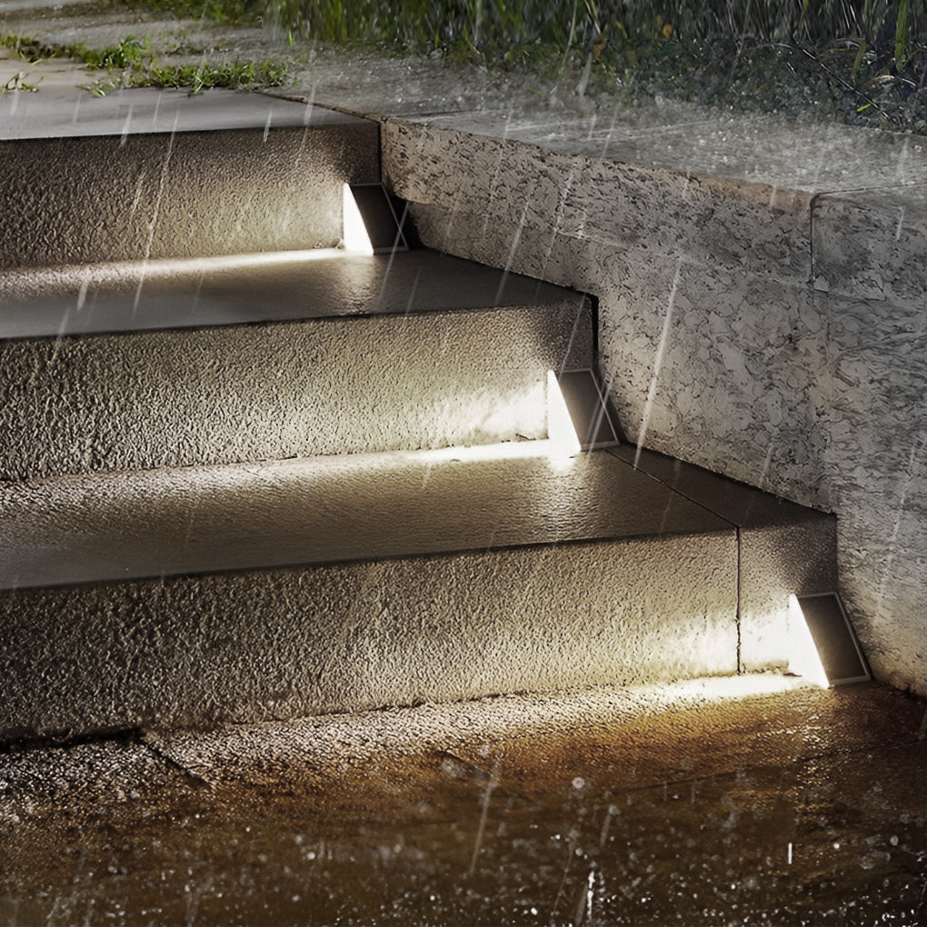 Solar powered lights for steps illuminating wet stone stairs, demonstrating weather resistance and reliable lighting.