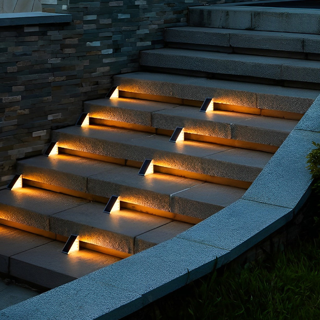 Warm solar powered lights for steps installed on wide outdoor stairs, adding decorative accent lighting at night.