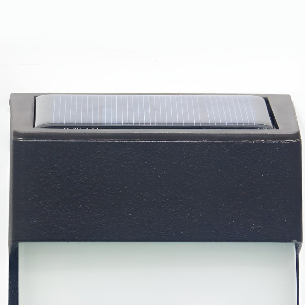 Solar powered outdoor sconces with black frame and solar panel on top, close-up view.