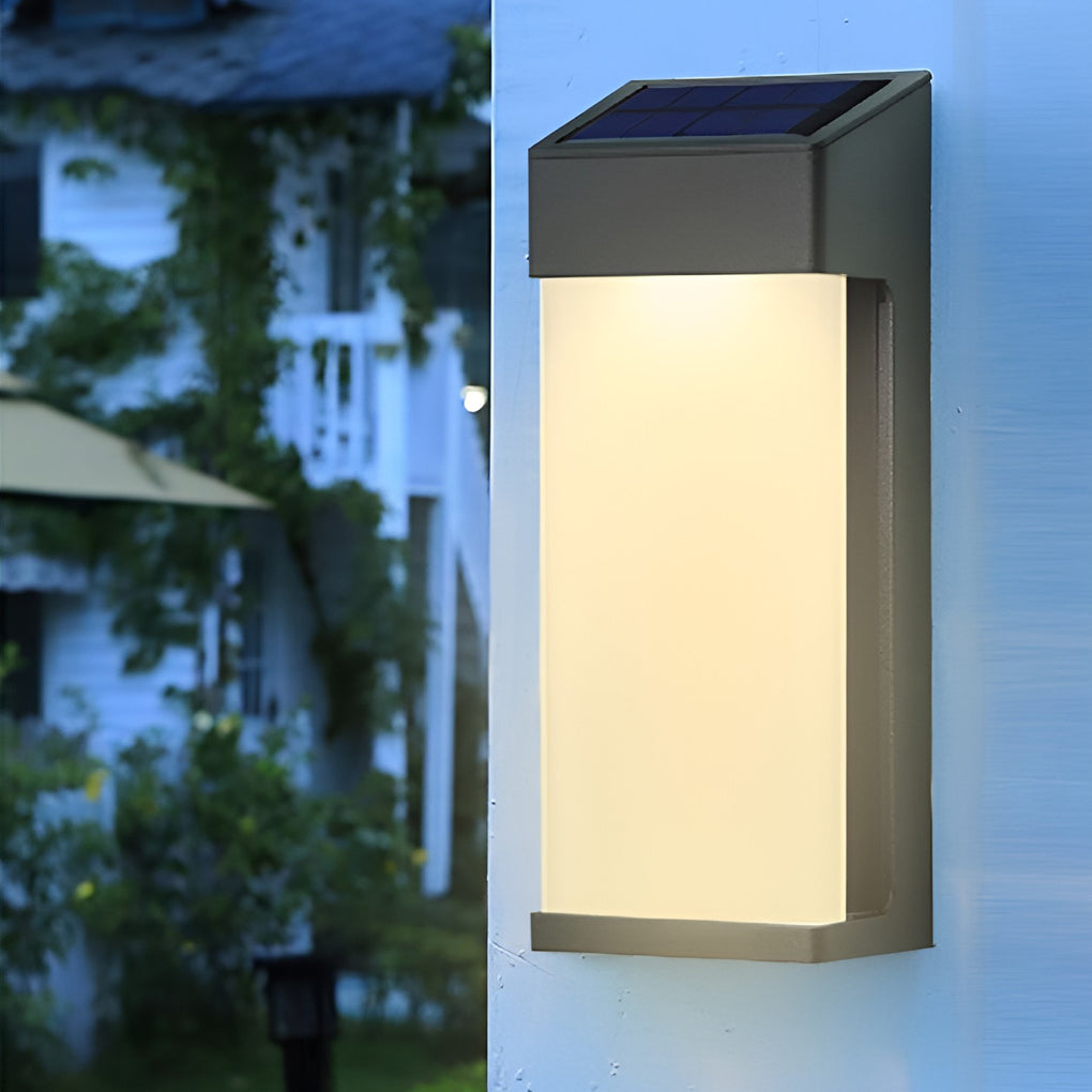 Solar powered outdoor sconces with black frame and warm glow mounted on white exterior wall.