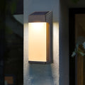 Solar powered outdoor sconces with modern black frame mounted on exterior wall at dusk.