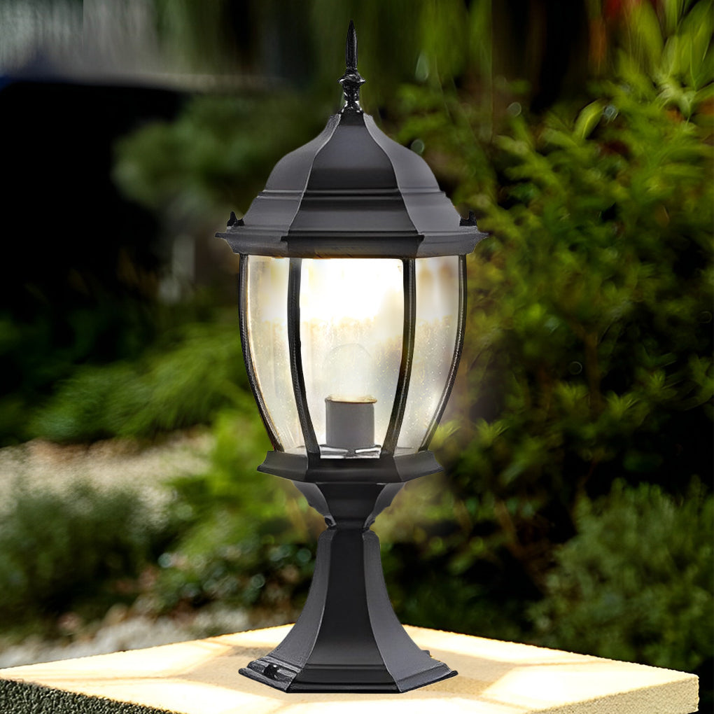 Solar powered pillar lights providing warm light beside a decorative wall.