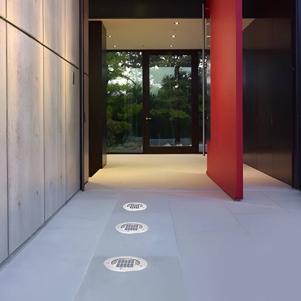 Stainless steel recessed floor lighting with solar panel and LED lights for outdoor pathway illumination.
