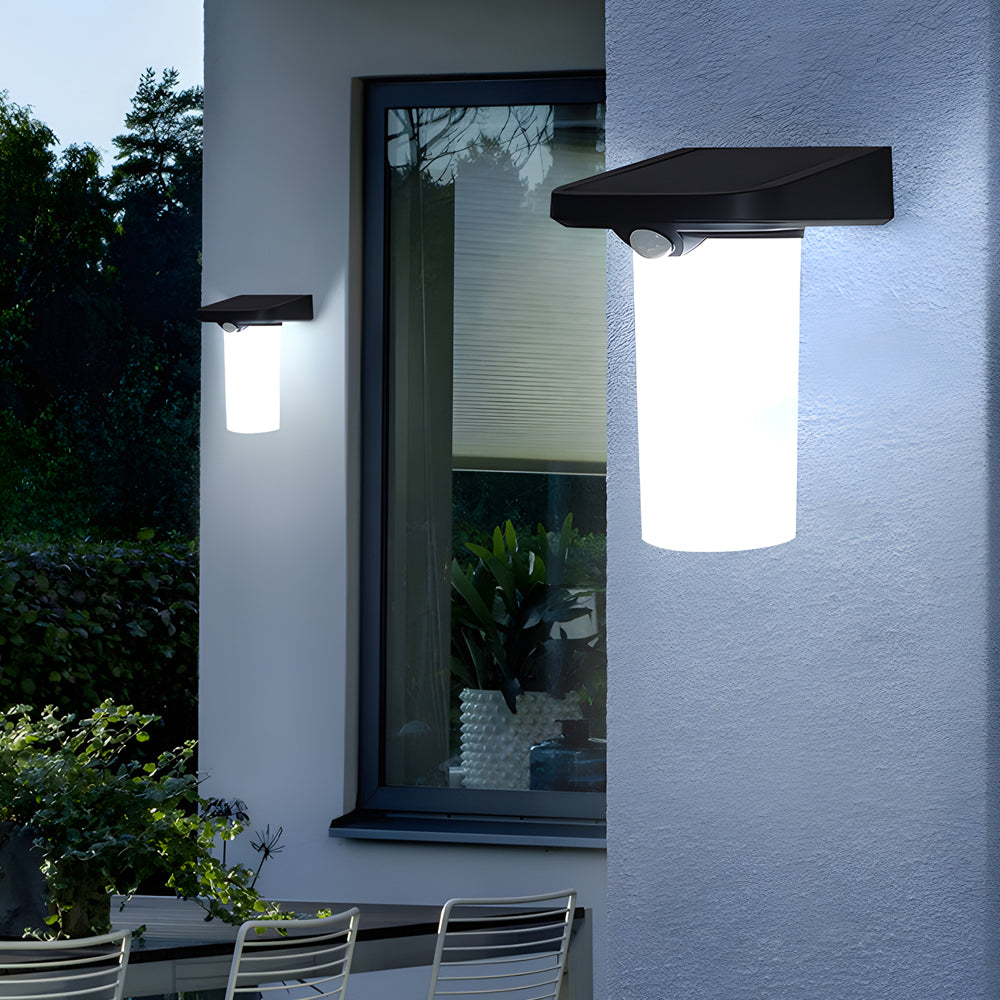 Solar wall lamp with motion sensor providing bright light on an exterior wall.