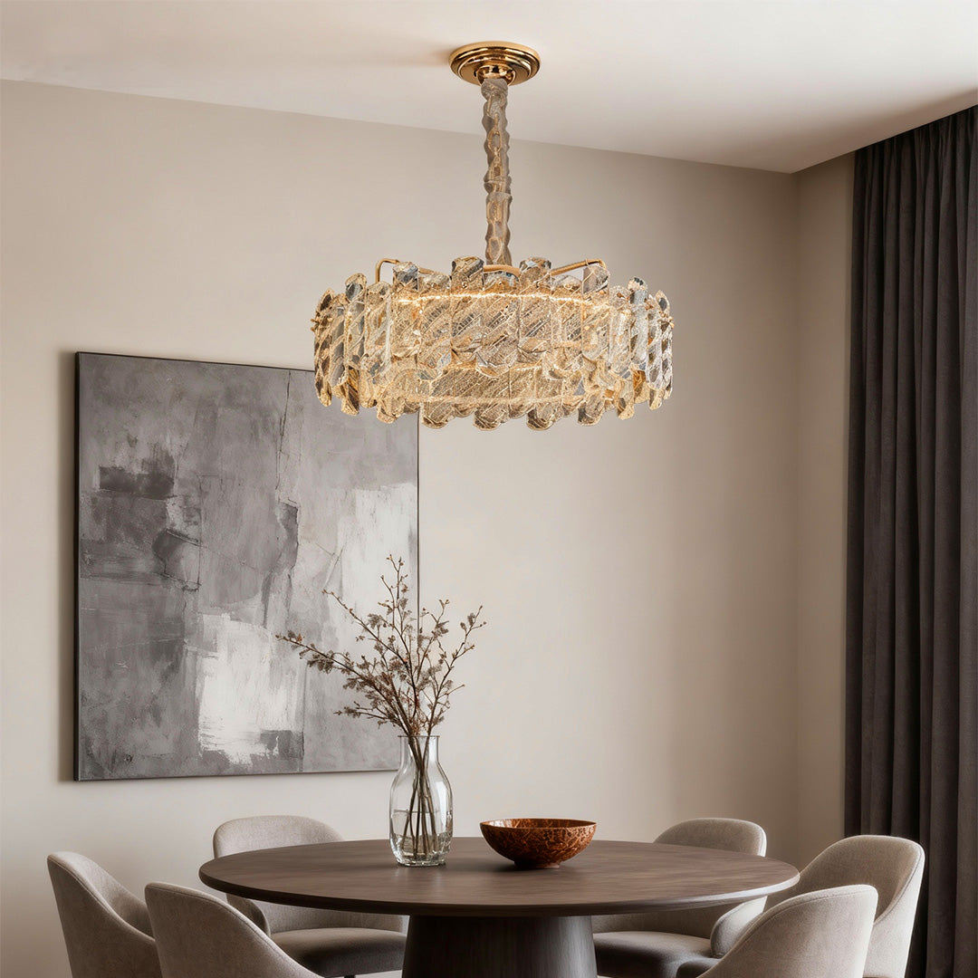 Sophisticated Nordic chandelier with glass shade chandelier styling creating statement piece in minimalist dining room with marble wall.