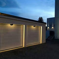 Sophisticated white outdoor wall lights featuring glass shade chandelier influence in minimalist dome configuration for uniform illumination.