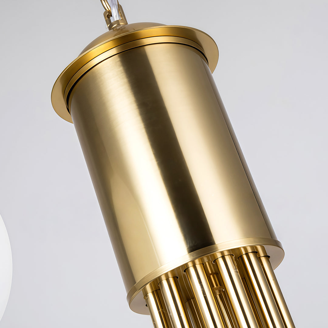 Close-up of the chandelier’s polished brass cylinder body showing premium metal texture.
