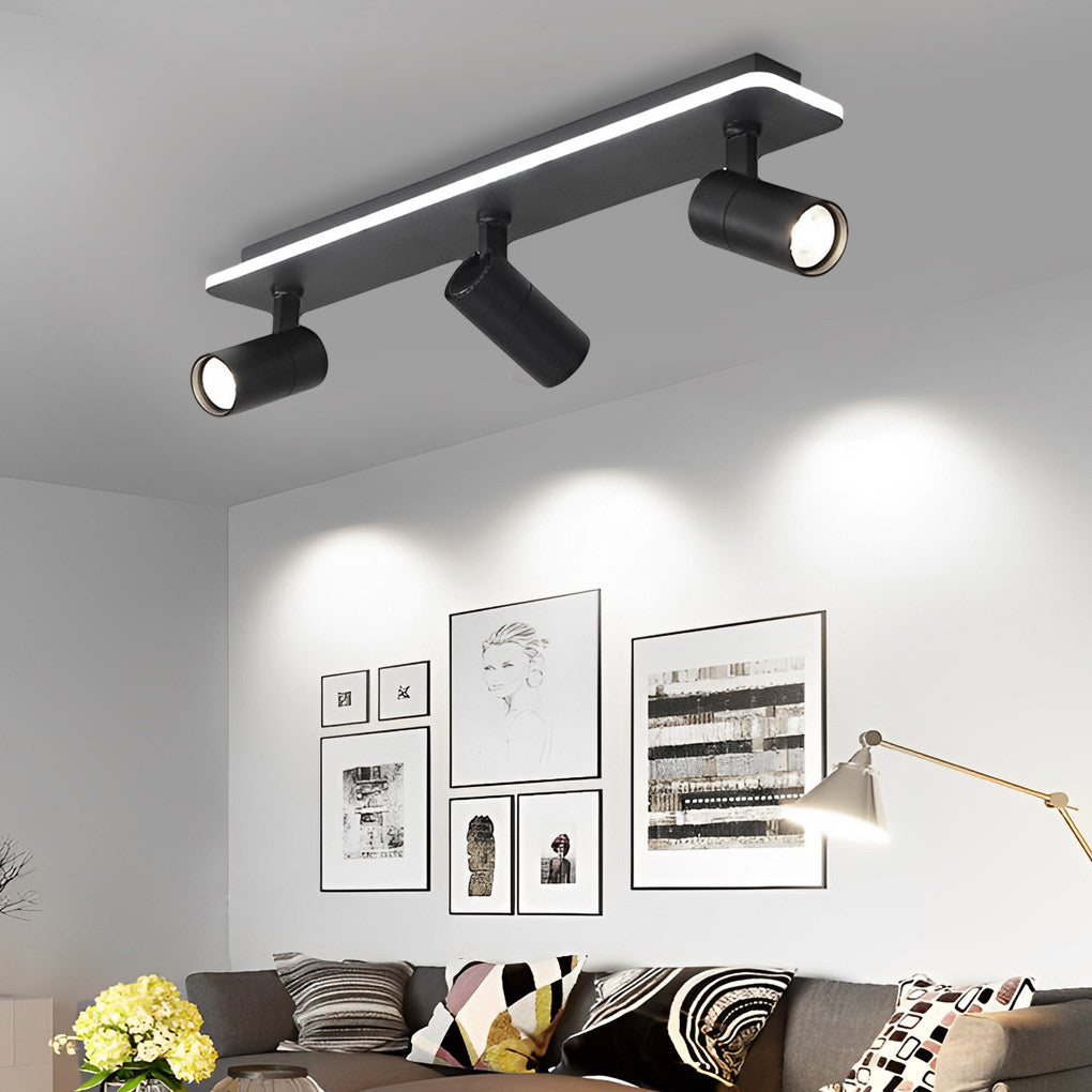 Spotlight Fixture lighting a living room wall display, combining linear LED glow with adjustable spot heads.