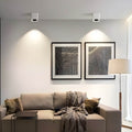 Spotlight LED square with dual light heads, installed in a modern living room.