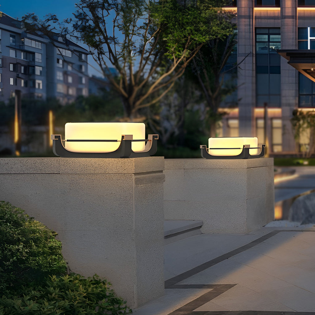 Square acrylic pier light placed on concrete ledges, enhancing urban residential outdoor spaces after sunset.