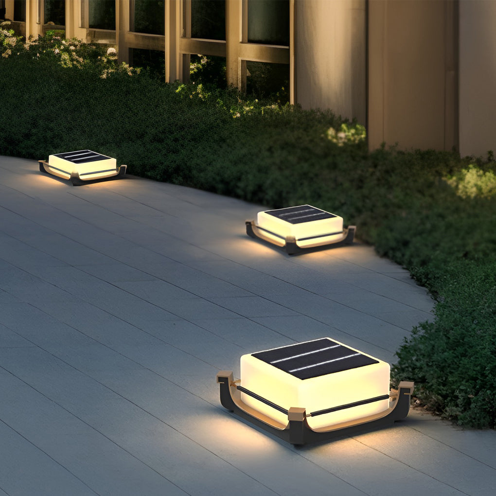 Square acrylic pier light installed along a modern paved pathway, offering subtle guidance lighting at night.