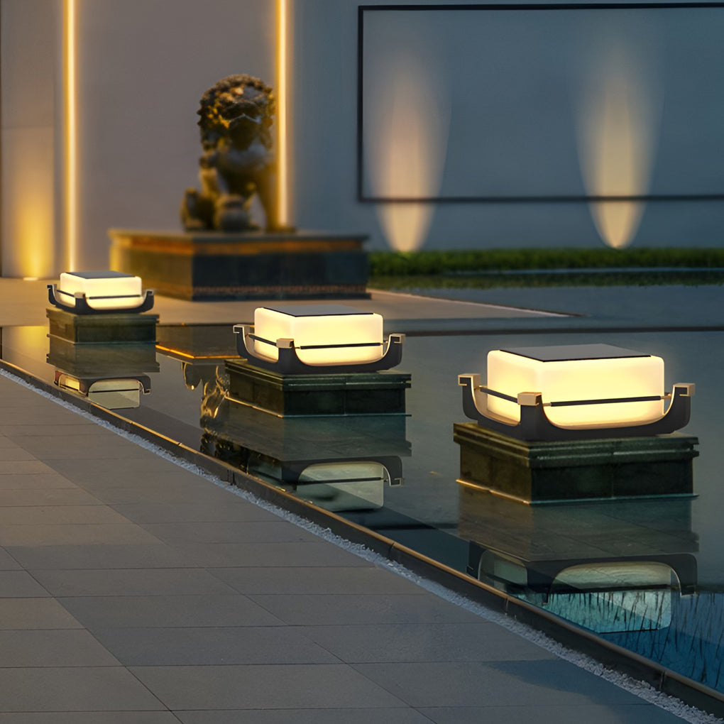Square acrylic pier light installed beside a modern outdoor pool, creating soft ambient pathway illumination at dusk.