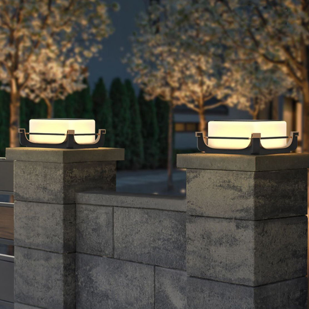 Square acrylic pier light mounted on square stone columns, creating balanced symmetry in outdoor entrance lighting.