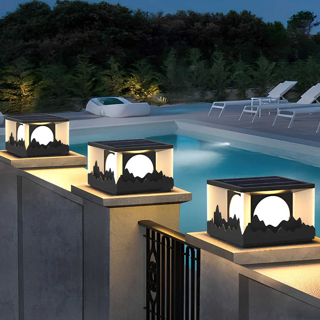 Square outdoor pillar lights casting a gentle glow near a poolside area.