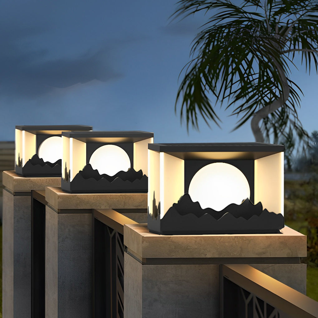 Square outdoor pillar lights providing warm light beside a wooden fence.