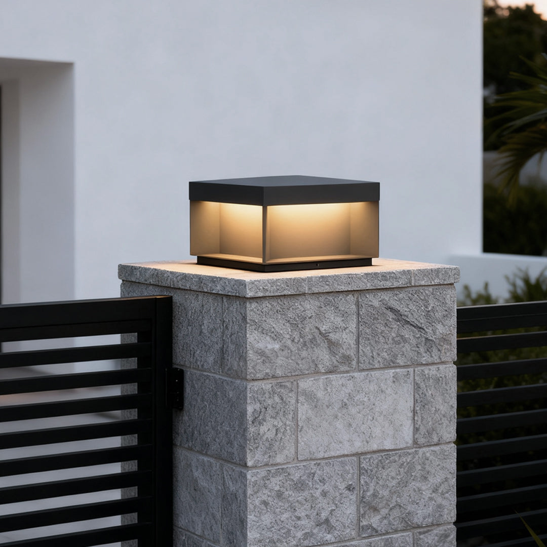 Square solar deck lights placed on tall stone column for contemporary outdoor lighting.