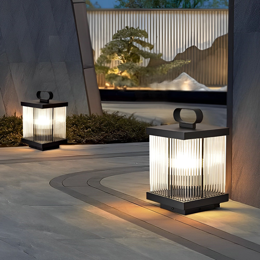 Square solar garden lanterns lining a modern outdoor walkway at night.
