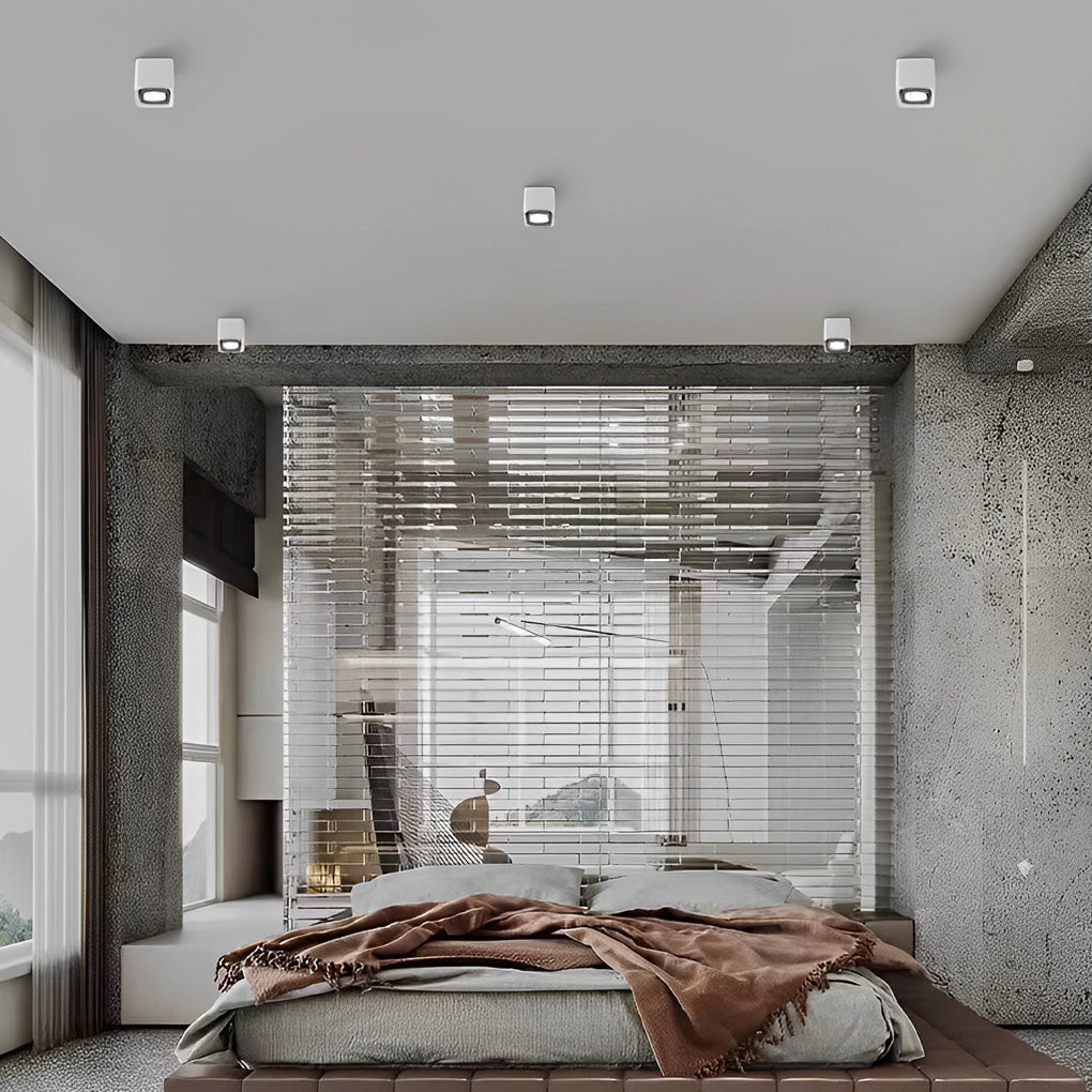 Surface mounted spot light with square design on white ceiling.