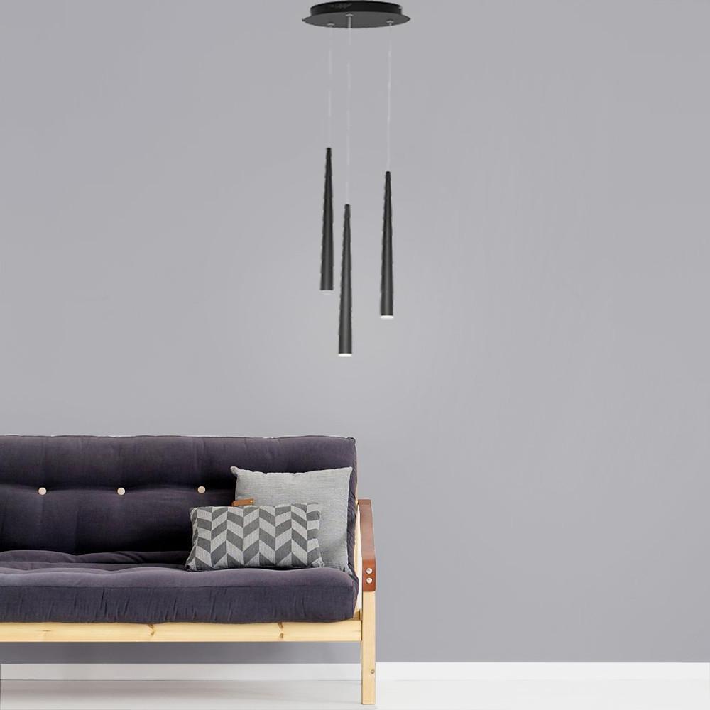 Staggered black multi head pendant lights for modern living room lighting hanging over a sofa.