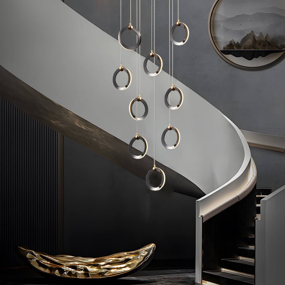 Staircase lighting chandelier with a close-up of its cascading rings and warm light.