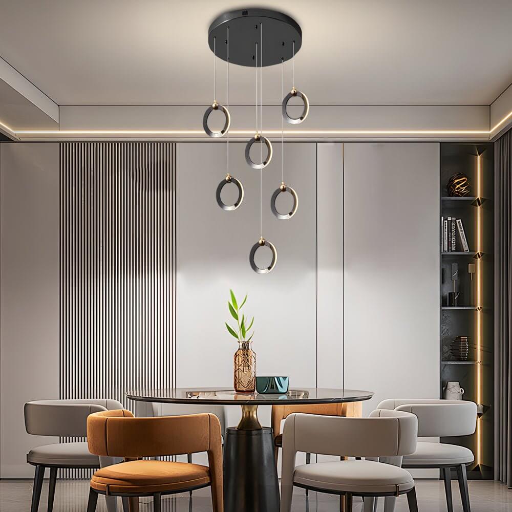 Staircase lighting chandelier with a close-up of its illuminated rings and structure.