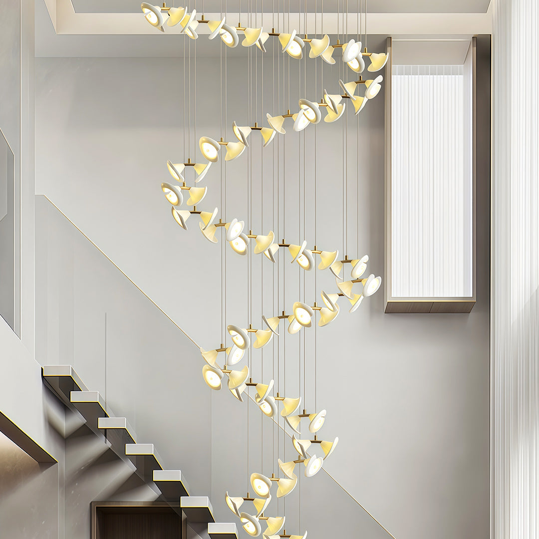 Modern brass ceramic chandeliers installed along a spiral staircase.