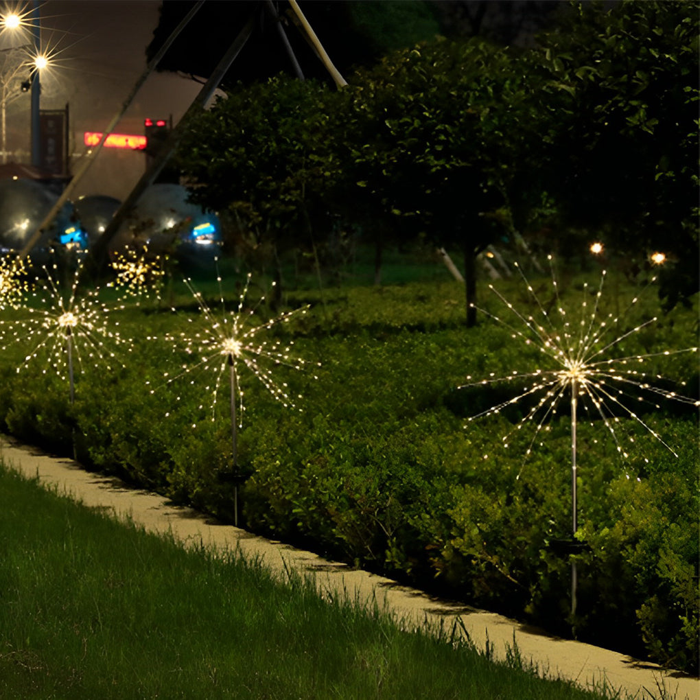 Starburst garden lights near a garden bed, enhancing the landscape with a radiant light display.