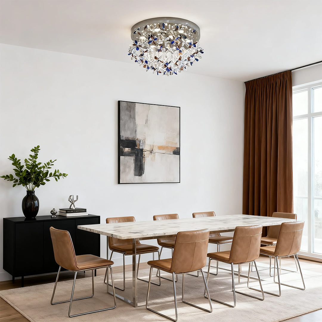 Statement crystal flush mount lights installed in a minimalist modern dining room above a marble table.
