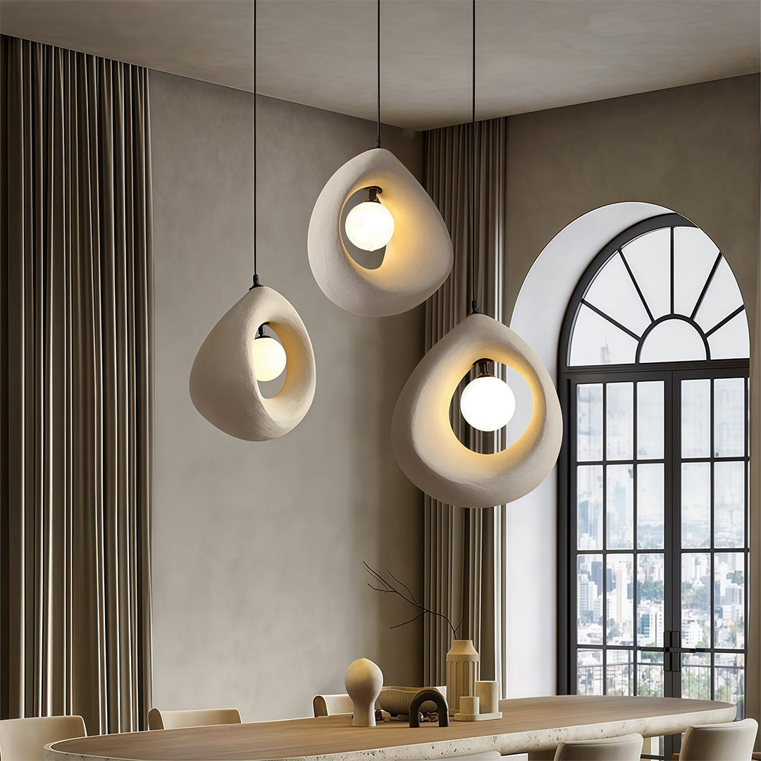 Statement pendant light with textured concrete shade adds a bold industrial touch while providing warm, focused lighting for modern interiors.