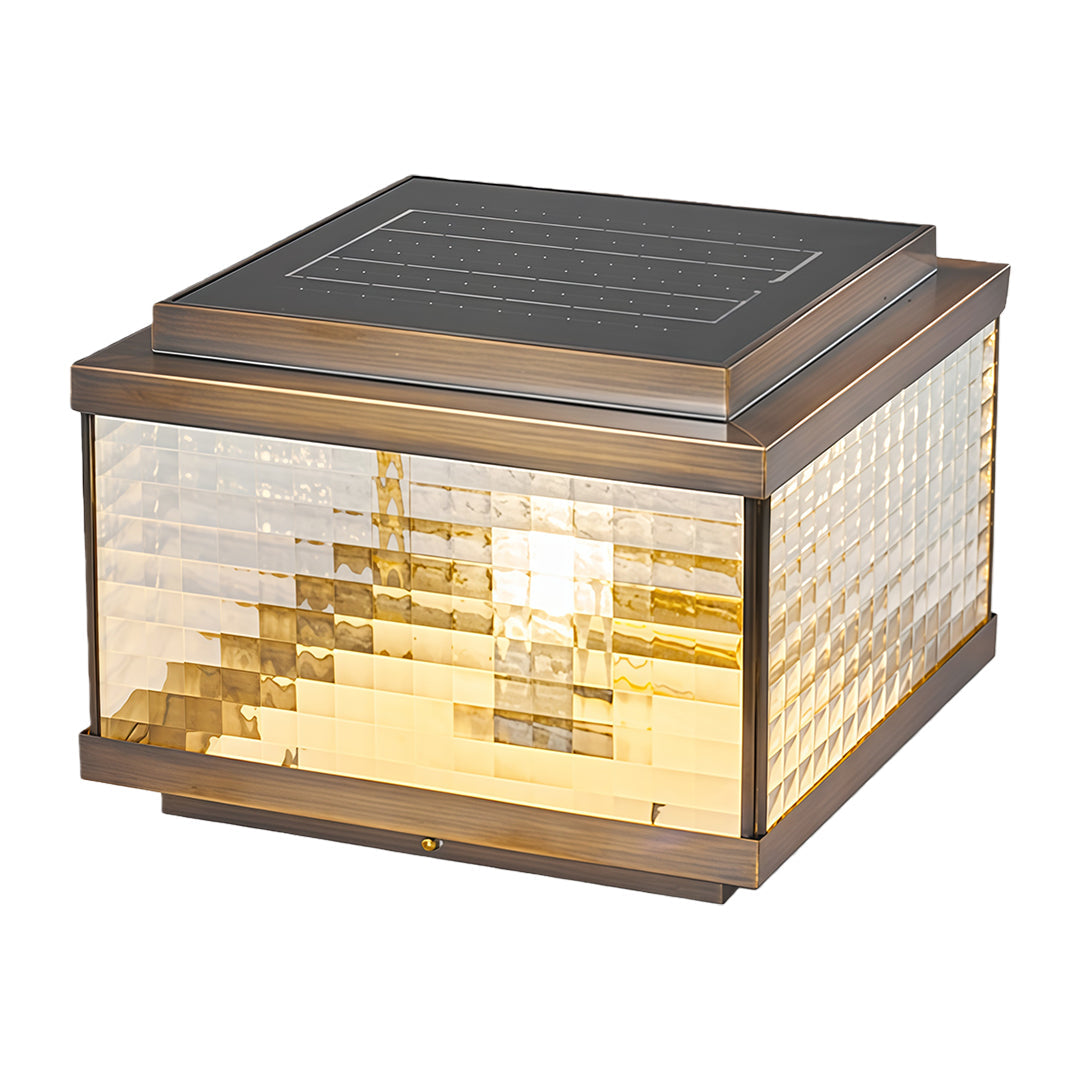 Decorative pillar cap light with stepped glass pattern emitting soft warm glow for entrance areas.