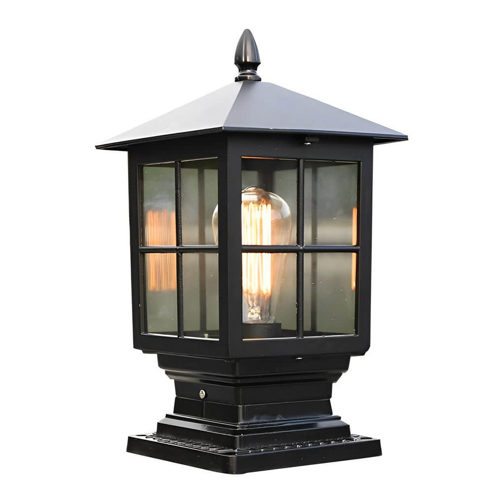 Stone light pillar with a black lantern, illuminating a pathway near a modern house.